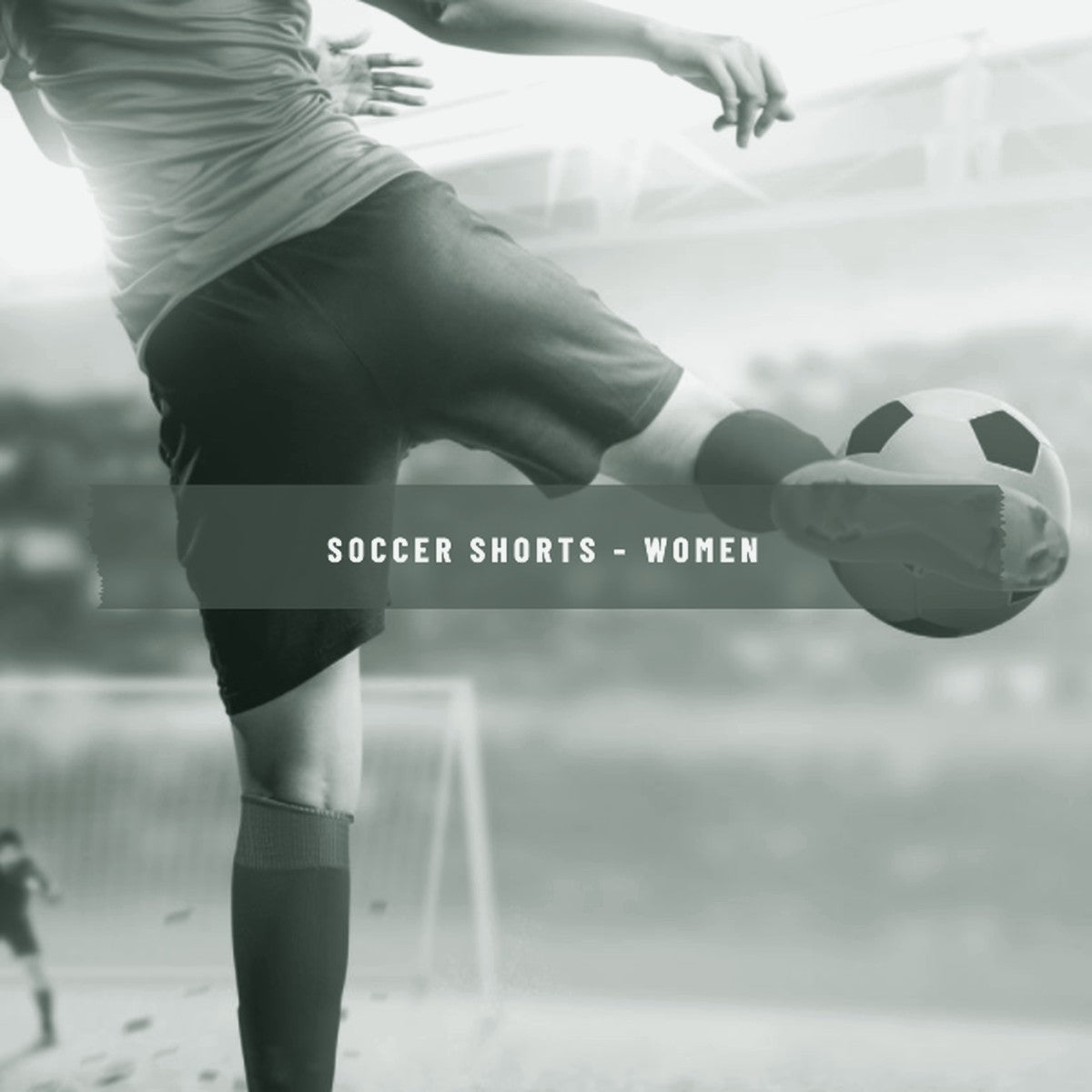 Woman kicking a soccer ball on the field wearing red socks and shorts, ThreaderPros women's custom soccer shorts