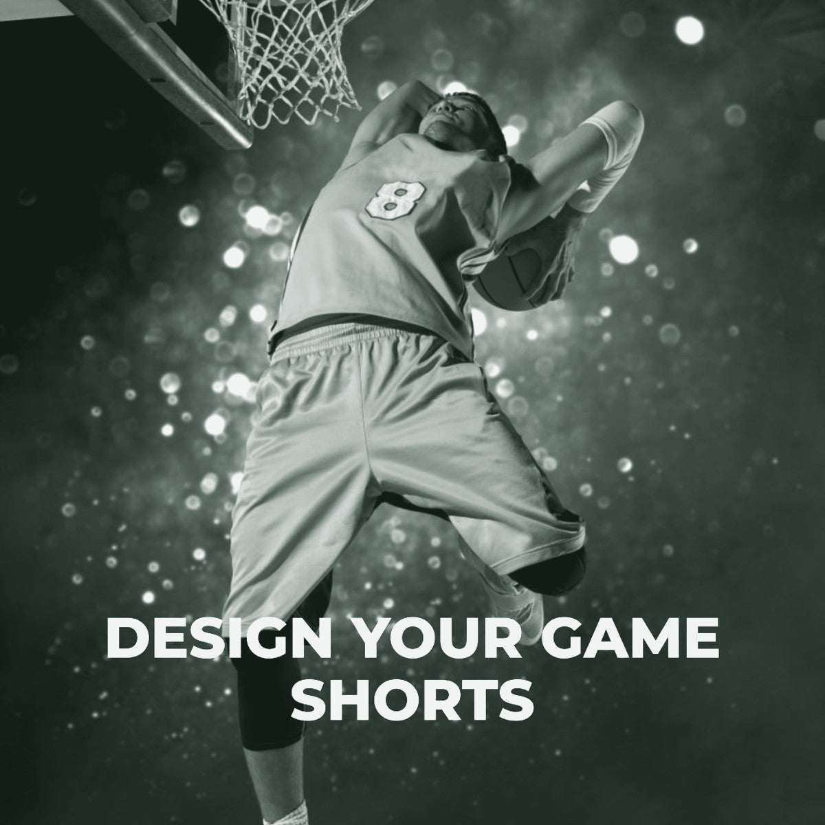 A male basketball player in a yellow jersey and shorts jumping to dunk a basketball, with the text 'Design Your Game Shorts' below. ThreaderPros custom basketball shorts.