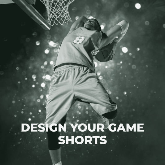 A male basketball player in a yellow jersey and shorts jumping to dunk a basketball, with the text 'Design Your Game Shorts' below. ThreaderPros custom basketball shorts.