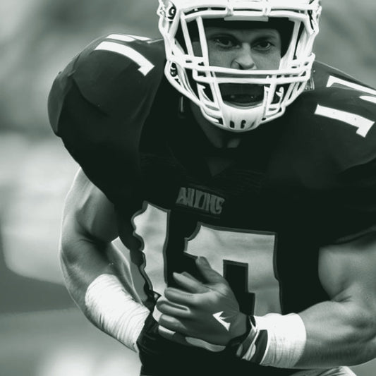 A male football player in a navy jersey with red gloves running with the ball, with the text 'Personalize your game jersey' below. ThreaderPros custom football jersey.